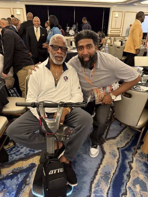 Derrick w NFL Hall of Famer Earl Campbell